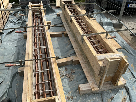 Close-up of reinforced concrete beam formwork prepared for casting at a construction site.