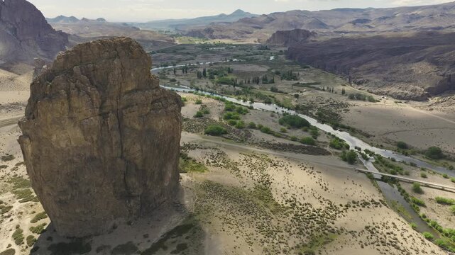 Aerial shot of the massive Piedra Parada volcanic rock formation located next to the Chubut River in the Patagonian steppe