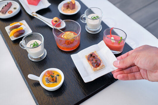 Hand picking gourmet appetizer from catering buffet