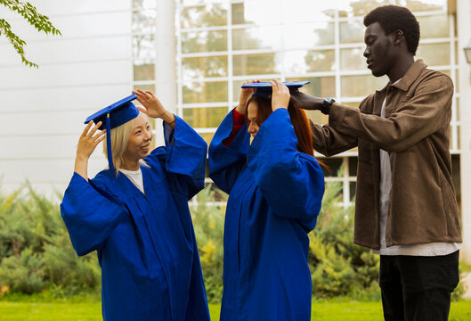 Friends celebrating graduation together outdoors