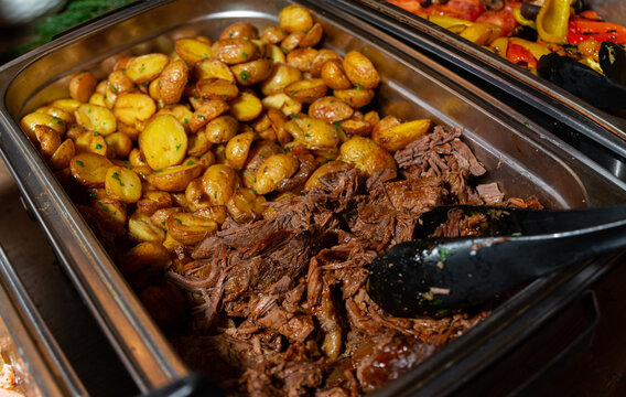 Buffet tray with roasted potatoes and shredded beef