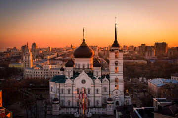 Naklejka premium Evening Voronezh cityscape. Tower of management of south-east railway and Annunciation Cathedral at sunset background