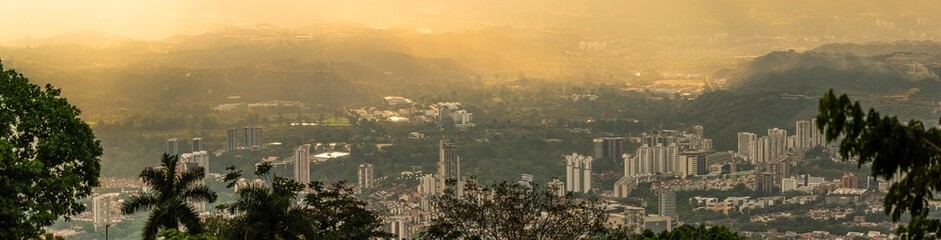 Golden Hour City Panorama Over Valley With Mountains and Tropical Trees
