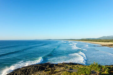 View from Corambirra Point in Australia Coffs Harbour of Boambee surf beach in morning light