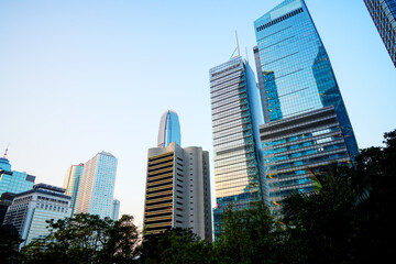 Fototapeta premium Skyscrapers tower glass buildings. Facade office buildings. High-rise bank building. Hong Kong Business District. Glass facade skyscraper building. HK commercial realty. Office towers as housing.