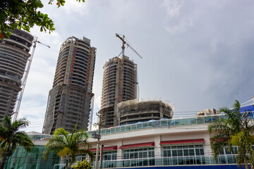 Fototapeta premium Santos, SP, Brazil - January 17 th, 2026: Towers under construction in the Ponta da Praia neighborhood, which is experiencing intense real estate speculation.