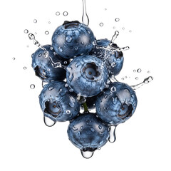 A cluster of blueberries with water splashing on them against a black background
