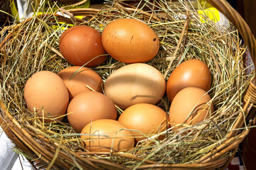 Fresh organic free range chicken eggs in rattan basket sold on local market