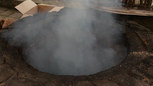 Traditional tandyr clay oven smoking heavily