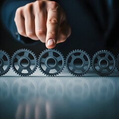 Hand adjusting metal gear on table representing change management transformation, strategy alignment, process optimization and leadership intervention. Photo | copy space