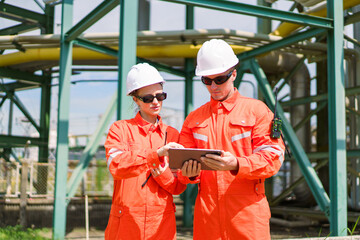 Male and female technicians checking operations using digital tablet