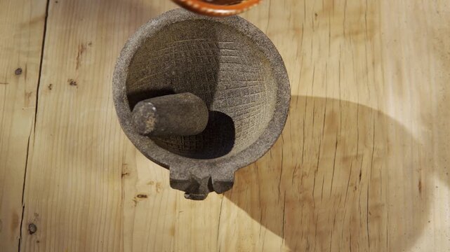 Curing traditional mexican molcajete with rice