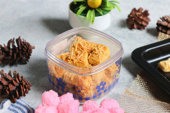 Savory cookies called kaasstengels or kastengel, type of kue kering adapted from Dutch, stored in jar.