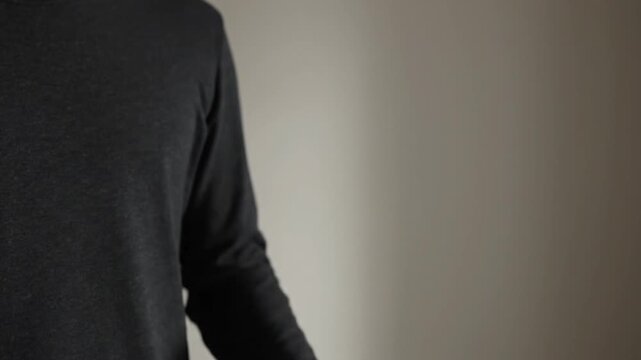 Man Gesturing with Hand in Studio Setting.