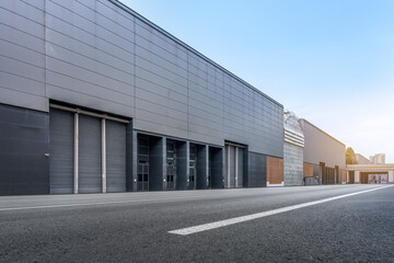 Naklejka premium Modern Industrial Warehouse Building with Large Loading Bays