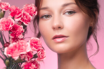 Beautiful Woman Holding Pink Carnations With Natural Radiant Makeup