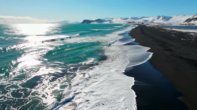 Aerial View of Ocean Waves Crashing onto a Beautiful Beach in Iceland