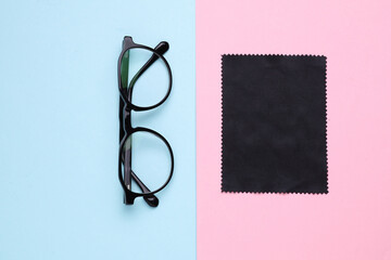 Classic Eyeglasses with case on pink blue background. Top view