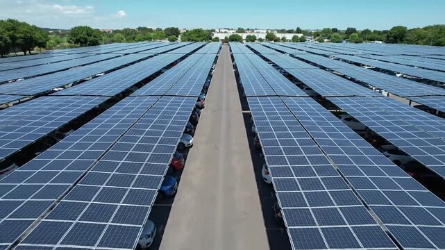 A vast parking lot with cars parked beneath solar panel carports.