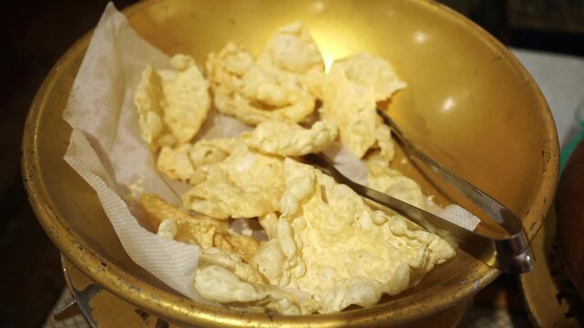 Crispy, sun-dried, Indian roasted papad seasoned with black pepper and spices, served as a crunchy accompaniment to a traditional meal.