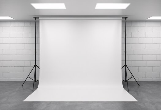 Professional photography studio setup with white seamless background and lighting equipment for product or portrait photography sessions