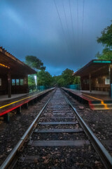 Obraz premium Train tracks, at the Chepe train station at night, in the town of Areponamichic, Chihuahua