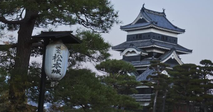 Majestic view of Japanese lantern and ancient 16th century Matsumoto castle at dusk