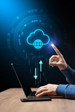 Person using laptop to upload data to cloud storage in digital workspace