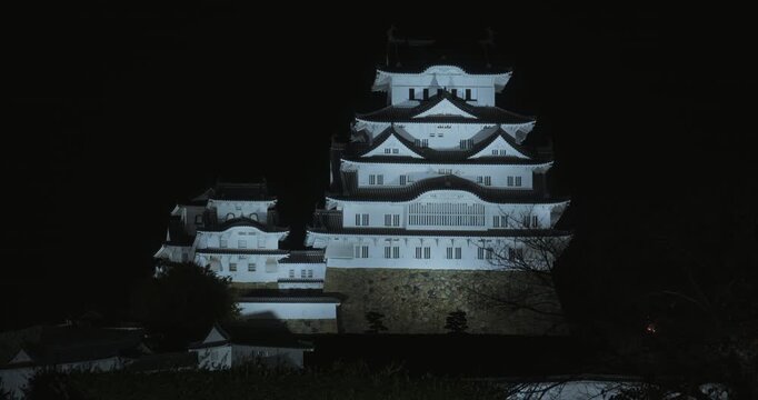 Spotlights shining on 16th century Matsumoto castle at night
