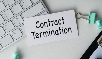 Contract Termination text on paper card on keyboard