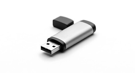 A silver metal USB flash drive with a black cap detached sits diagonally on a clean white surface showcasing the connector end.