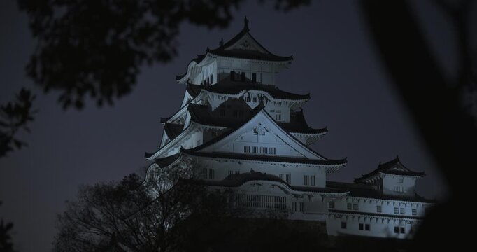 Faint glow on cinematic 16th century Matsumoto castle at dusk