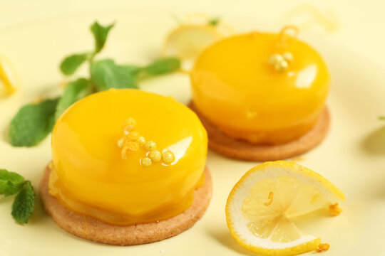 Delicious lemon cakes on yellow background, closeup