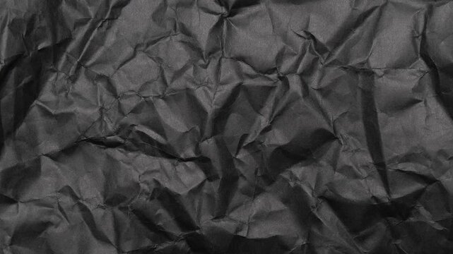 Stop motion of crumpled black paper texture, abstract loop background