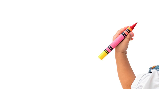 Child holds a large crayon ready for drawing isolated on transparent background cut out