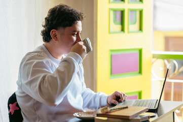 Man working remotely with laptop taking coffee break
