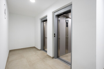 Modern Residential Building Elevator Lobby with Two Stainless Steel Lifts