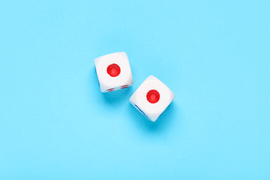 Dices with red and blue pips on blue background