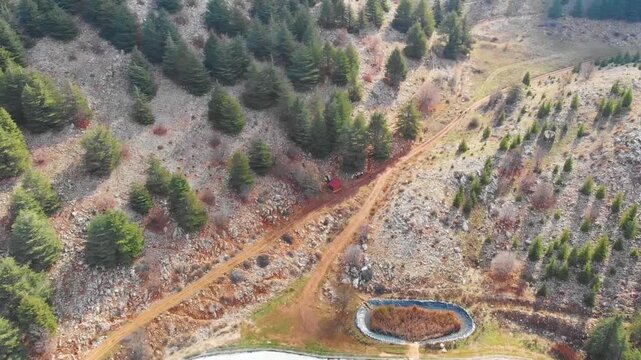 Top-down drone video showing the shape of Barouk Lake surrounded by trees and rugged terrain in Lebanon. Great for environmental, tourism, and outdoor lifestyle campaigns