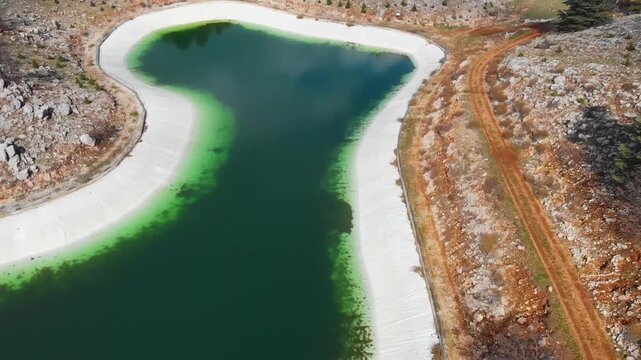 Drone flyover footage over Barouk Lake reservoir and surrounding forested hills in Lebanon. Ideal for travel destination promos, nature documentaries, and environmental visuals