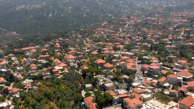 Drone flyover of Douma Village, Tannourine&mdash;hillside homes, greenery, and mountain terrain for tourism, real estate, and travel marketing.