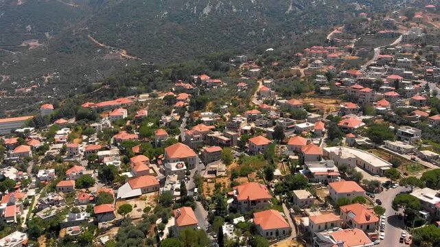 Aerial drone footage of Douma Village in the Tannourine region, Lebanon, showing hillside homes, greenery, and mountain scenery. Ideal for travel tourism, lifestyle, and destination marketing.