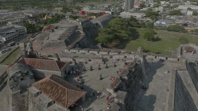 drone overlooking main tower of castillo san felipe going all the way the the west side flag n last part of the castillo, in cartagena, colombia