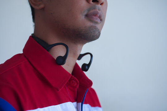 Man with Bone Conduction Headphones Around His Neck