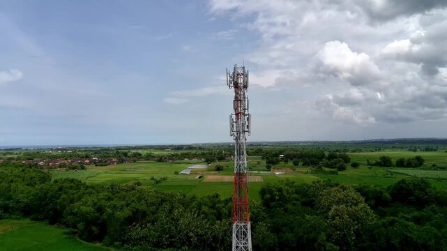 Aerial view of a Base Transceiver Station (BTS) tower or telecommunication tower from close range.