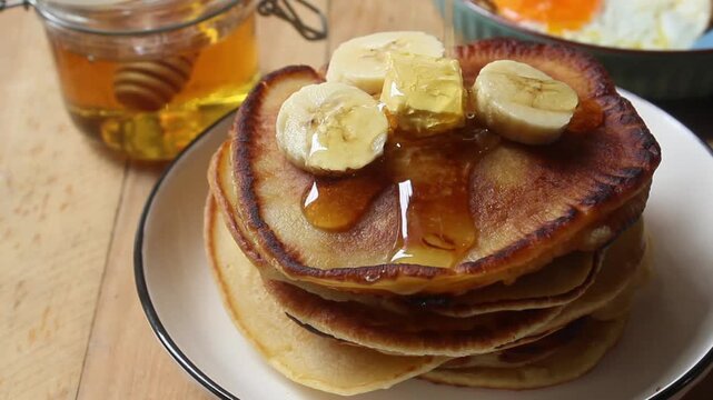 pour honey on top of the pancakes