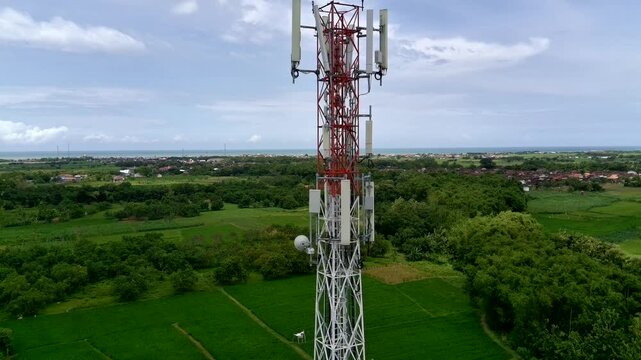 Aerial view of a Base Transceiver Station (BTS) tower or telecommunication tower from close range.