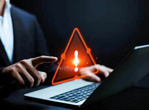 
Cyber security warning concept, businessman pointing at laptop with glowing red alert icon, data breach notification, online threat detection, information protection and corporate risk management str