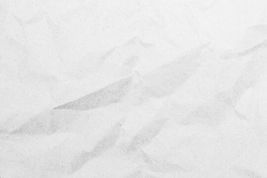 White recycled craft paper texture as background. Grey paper texture, Old vintage page or grunge vignette of old newspaper. Pattern rough art creased grunge letter. Hardboard with copy space for text.