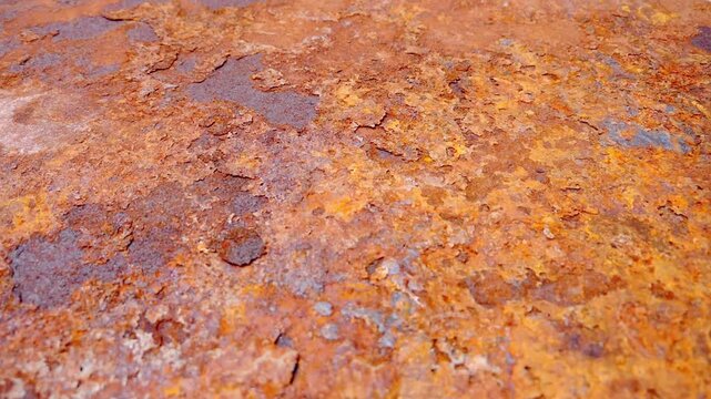 Close-up texture of rusted metal, showcasing shades of orange and brown, and weathering effect